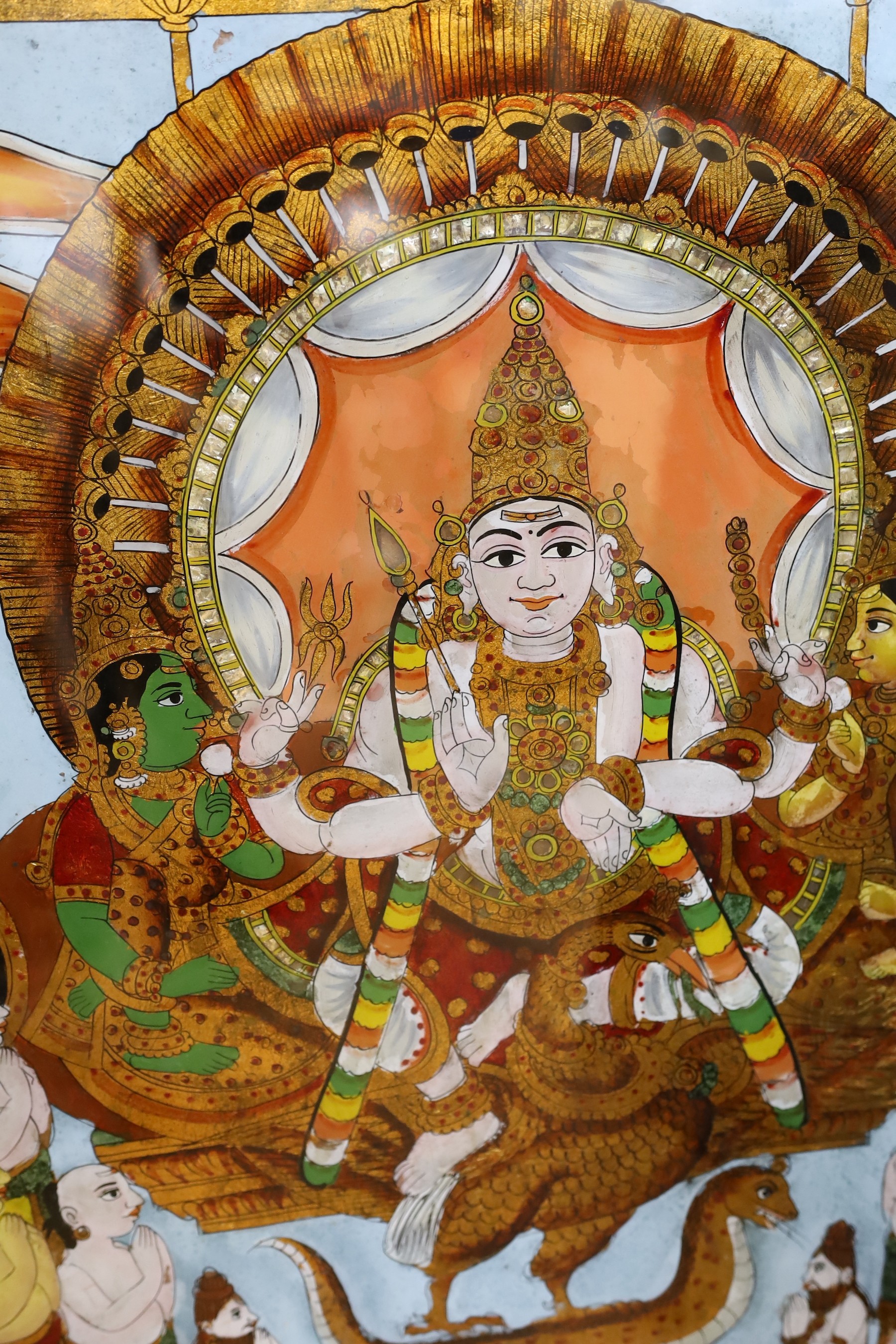 A collection of eight Indian reverse decorated glass pictures, 20th century, largest frame 70cm X 60cm